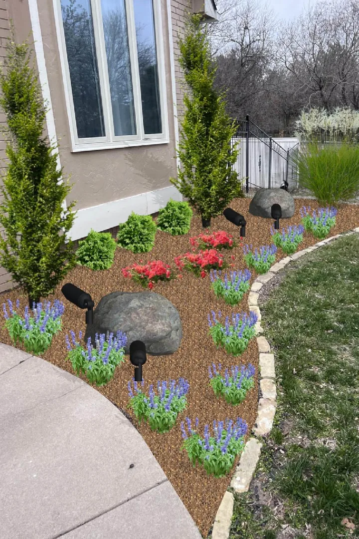 Landscape design rendering with evergreens, flowers, boulders, and lighting in a stone-edged garden bed