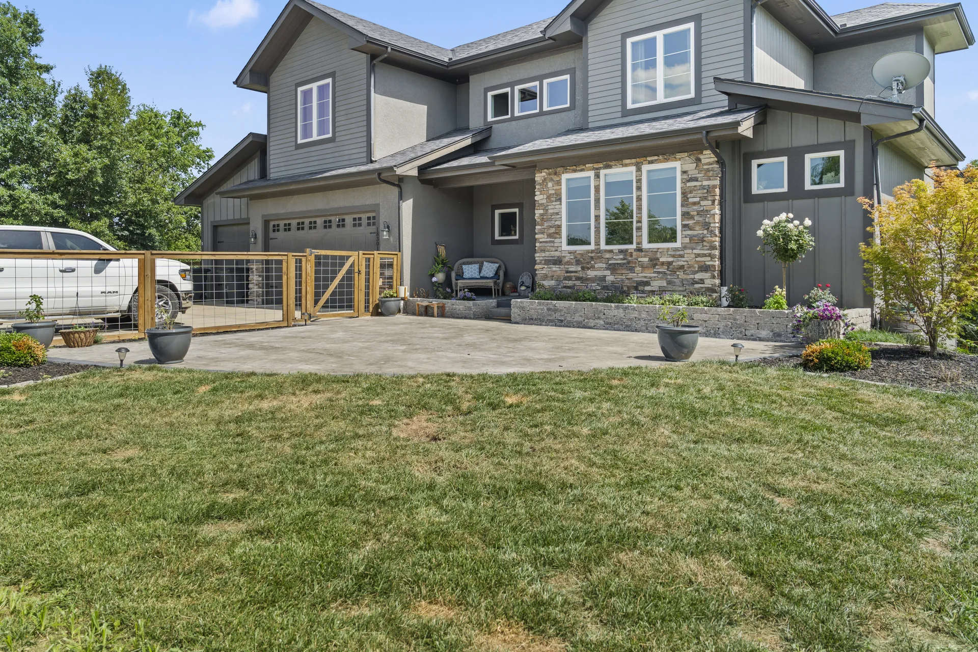 Ground-level view of the stone-faced home and patio