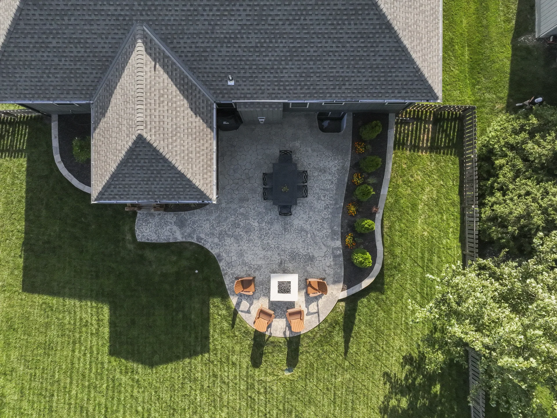 Overhead view of the paver patio and fire pit beside the covered deck