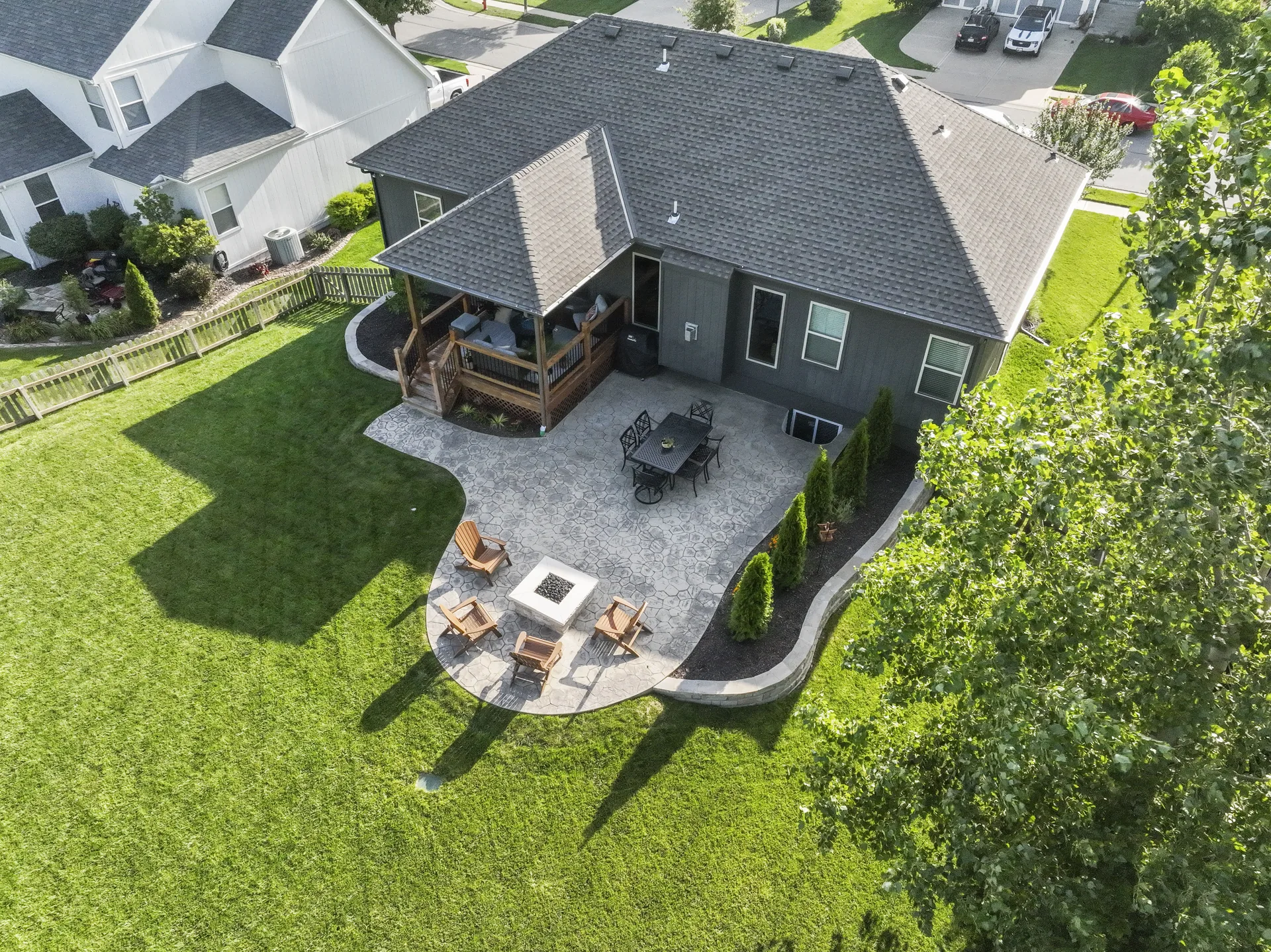 Aerial view showing the curved patio edge and surrounding lawn