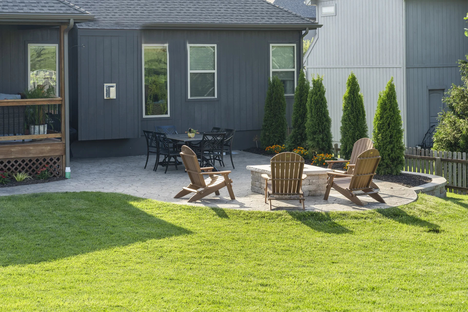Outdoor chairs around the square fire pit on the pavers