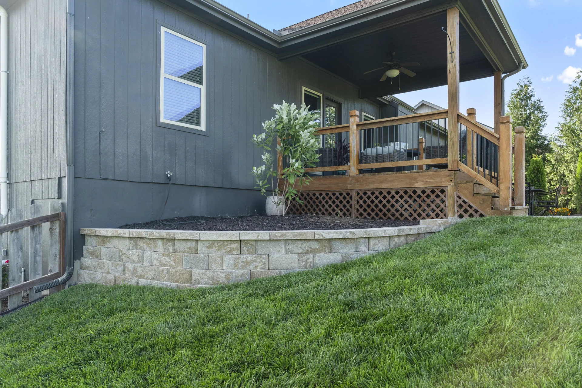 Covered deck edge above the landscaped patio