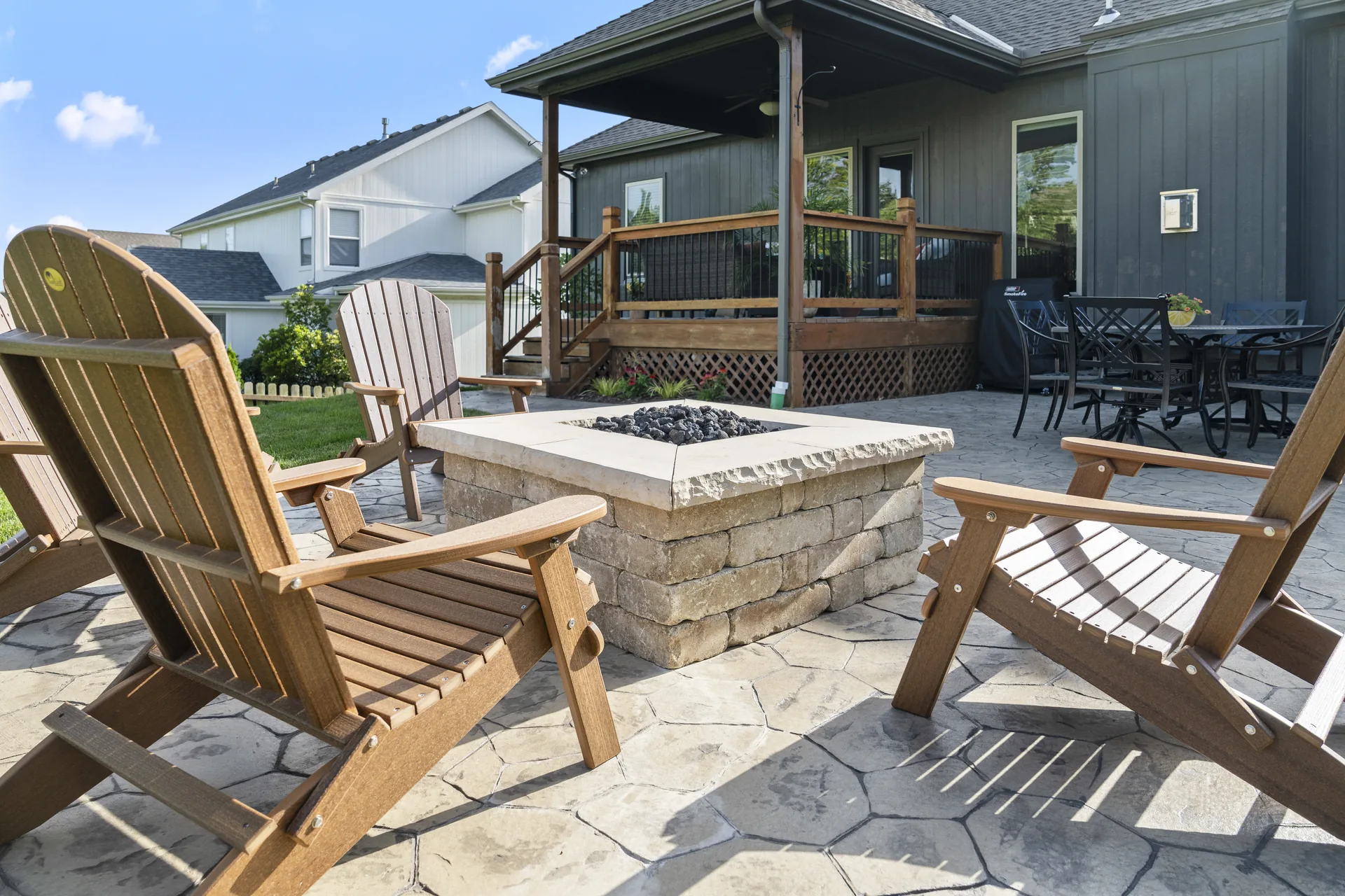 Close view of the stone fire pit and seating under the deck