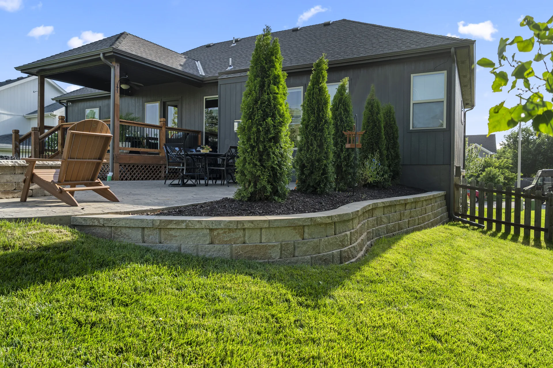 Low stone border separating the patio from the lawn