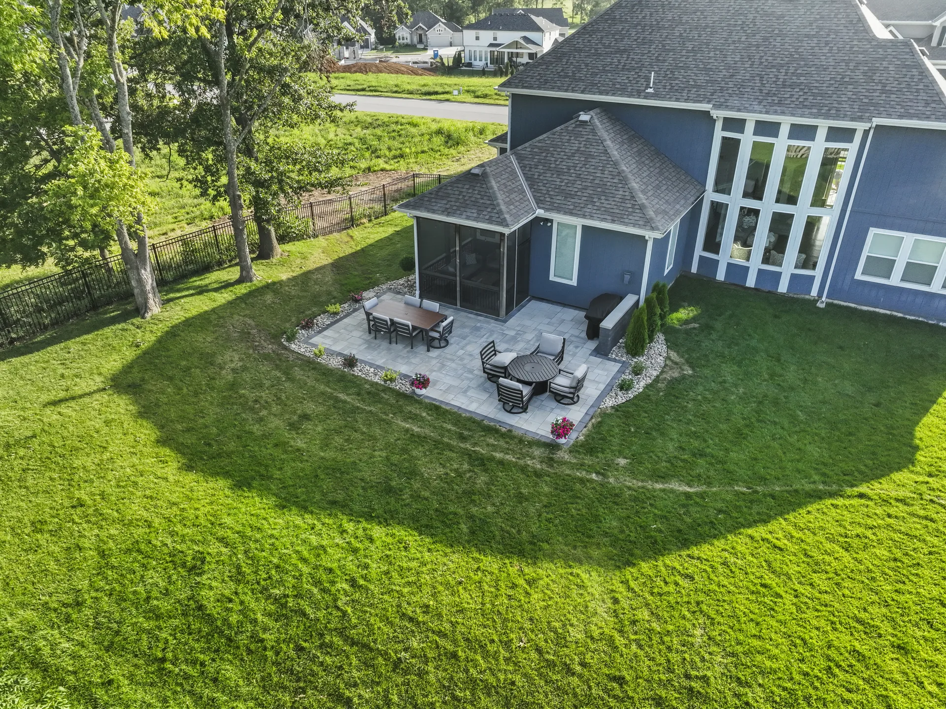Angled aerial view of the patio behind the house