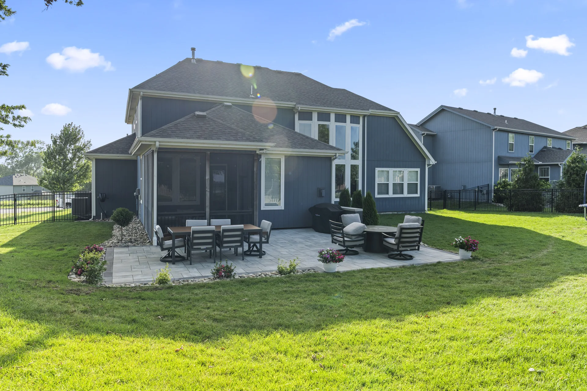 Lounge chairs on the patio with lawn behind