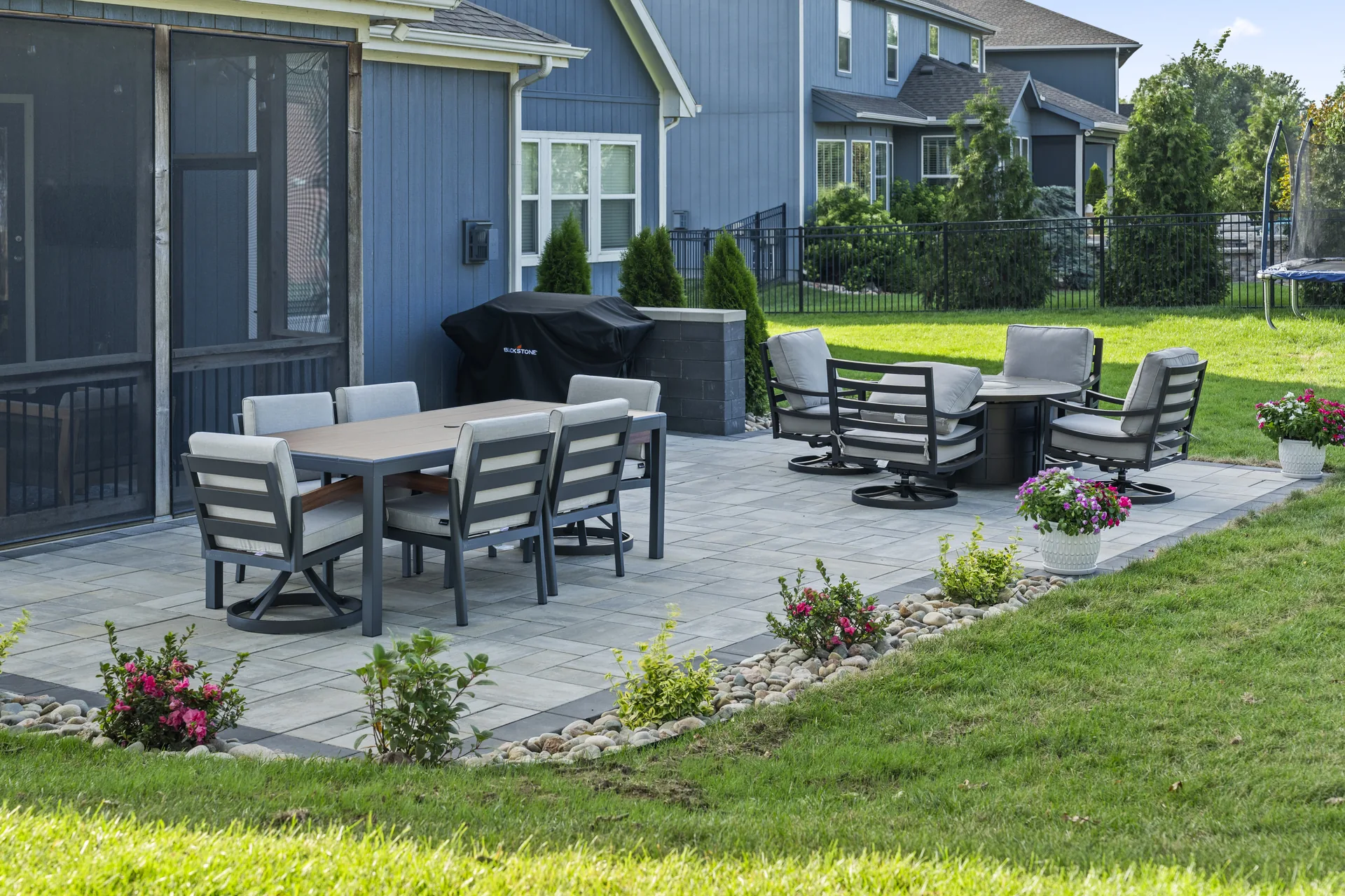 Patio beside the covered porch and flower beds