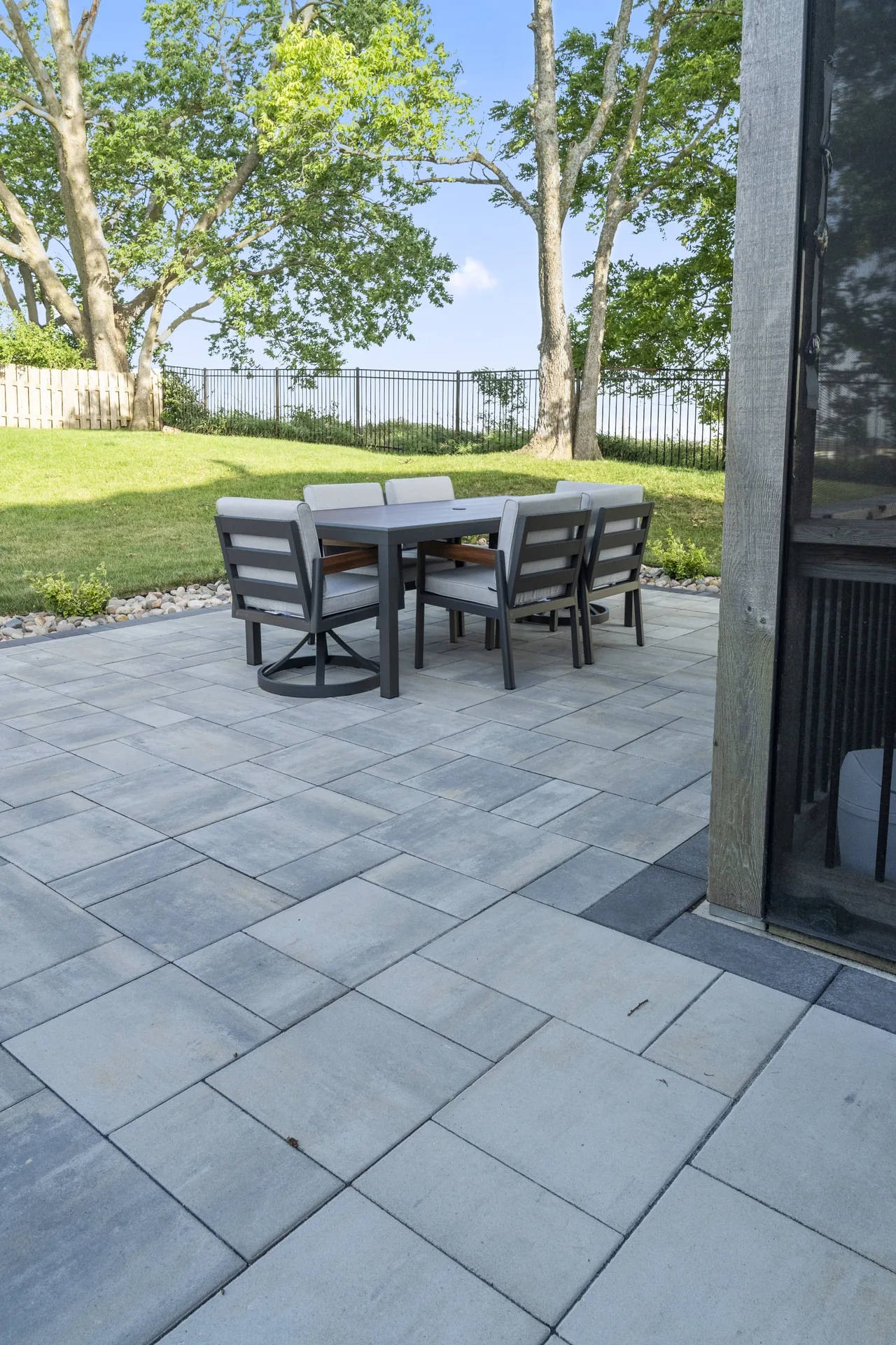 Paver surface and dining table at the patio edge