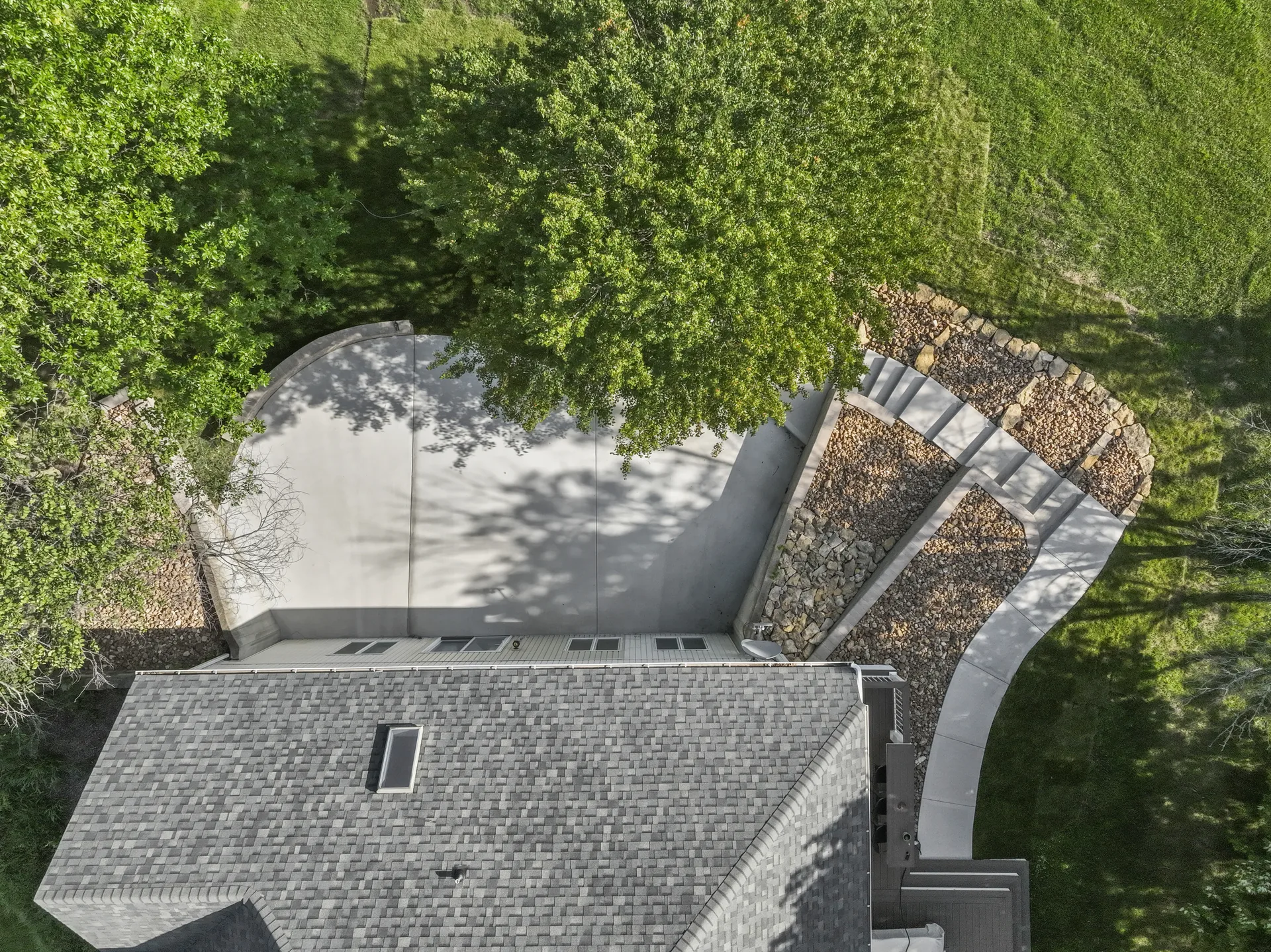 Overhead view of concrete paving and tiered retaining walls