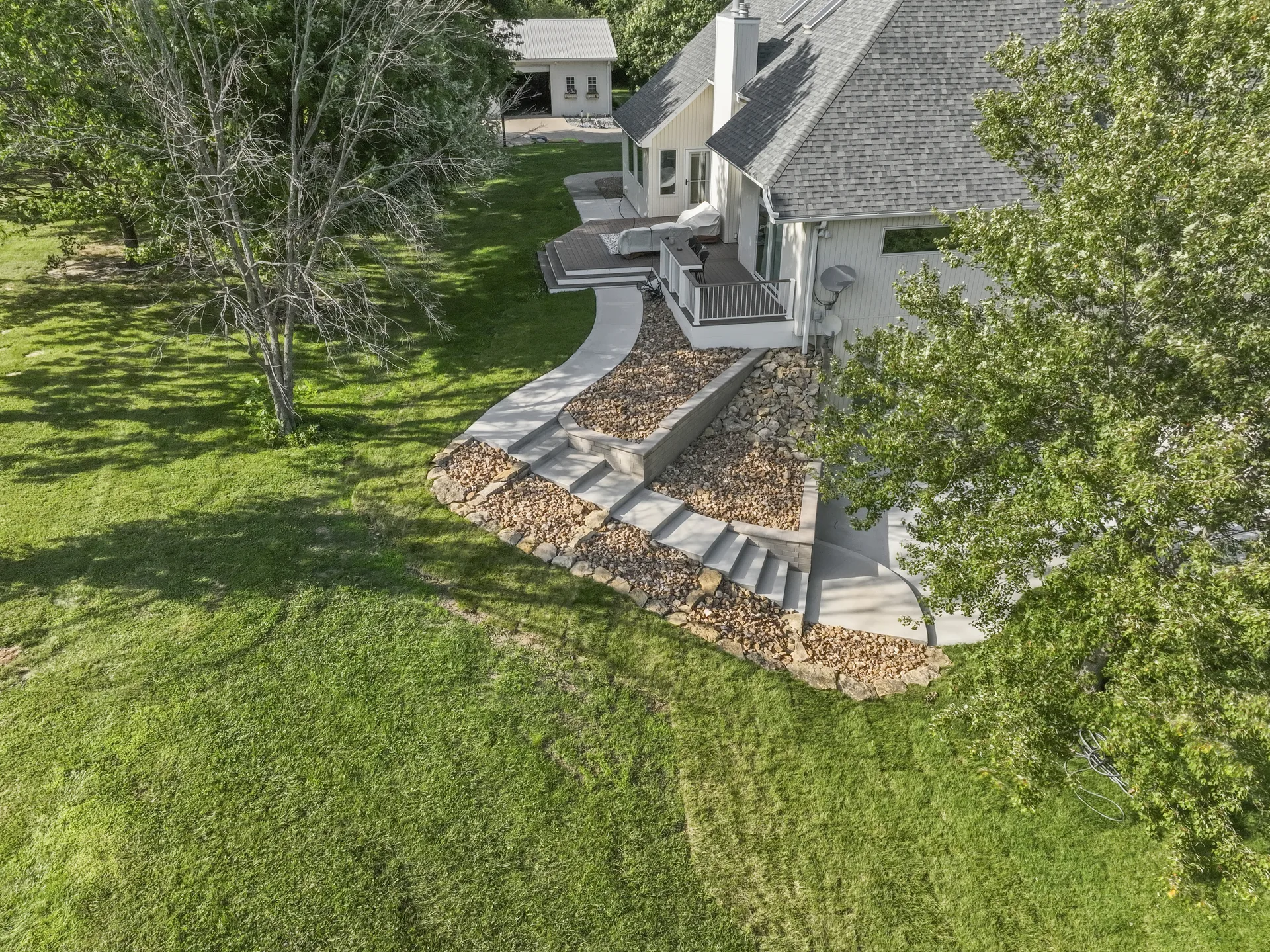 Aerial view of the patio, steps and upper lawn