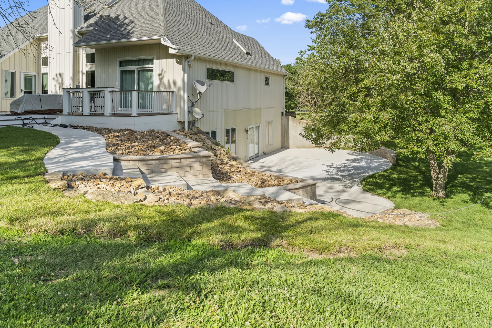 Ground-level overview of the concrete patio and tiered walls
