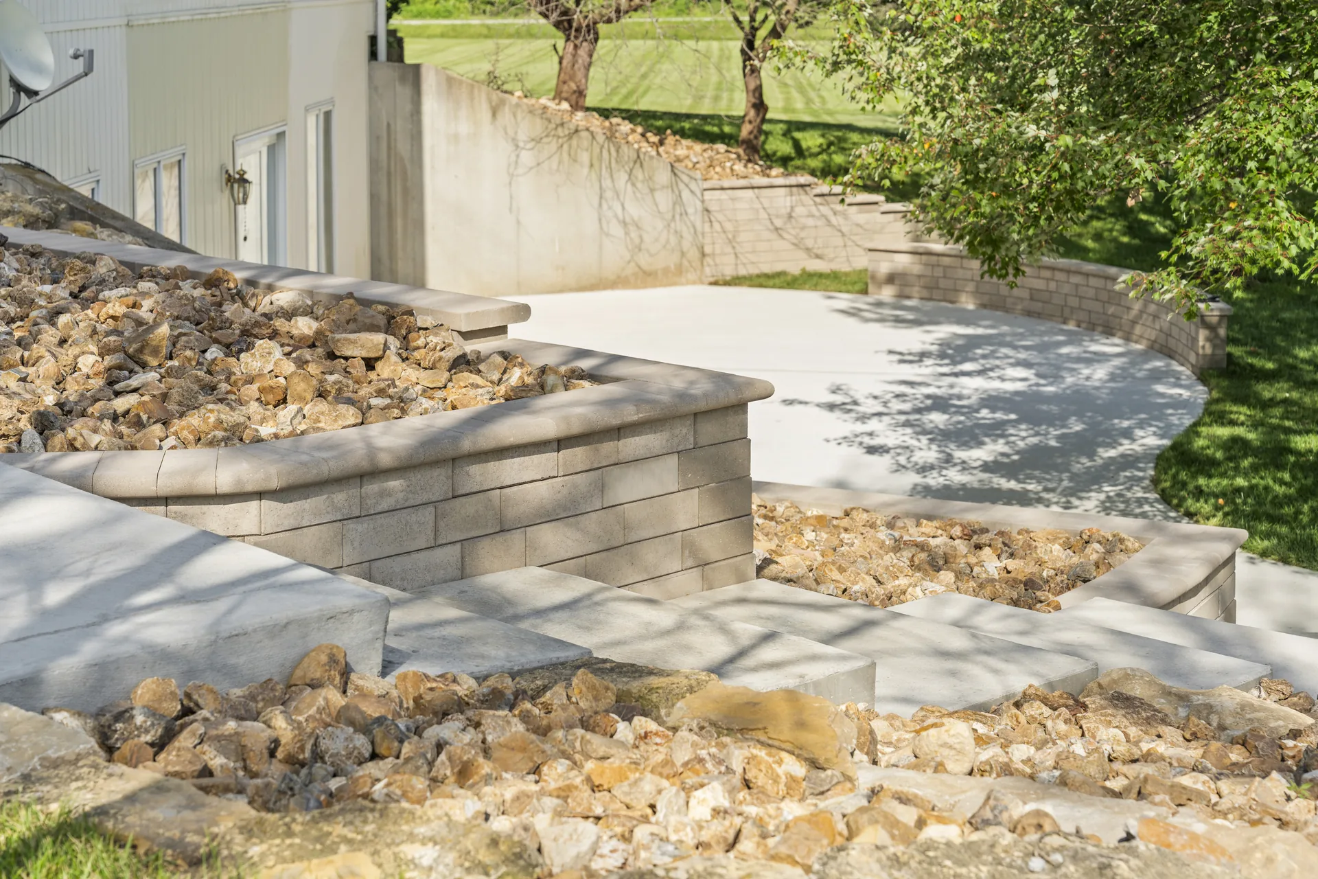 Block retaining wall beside the concrete slab