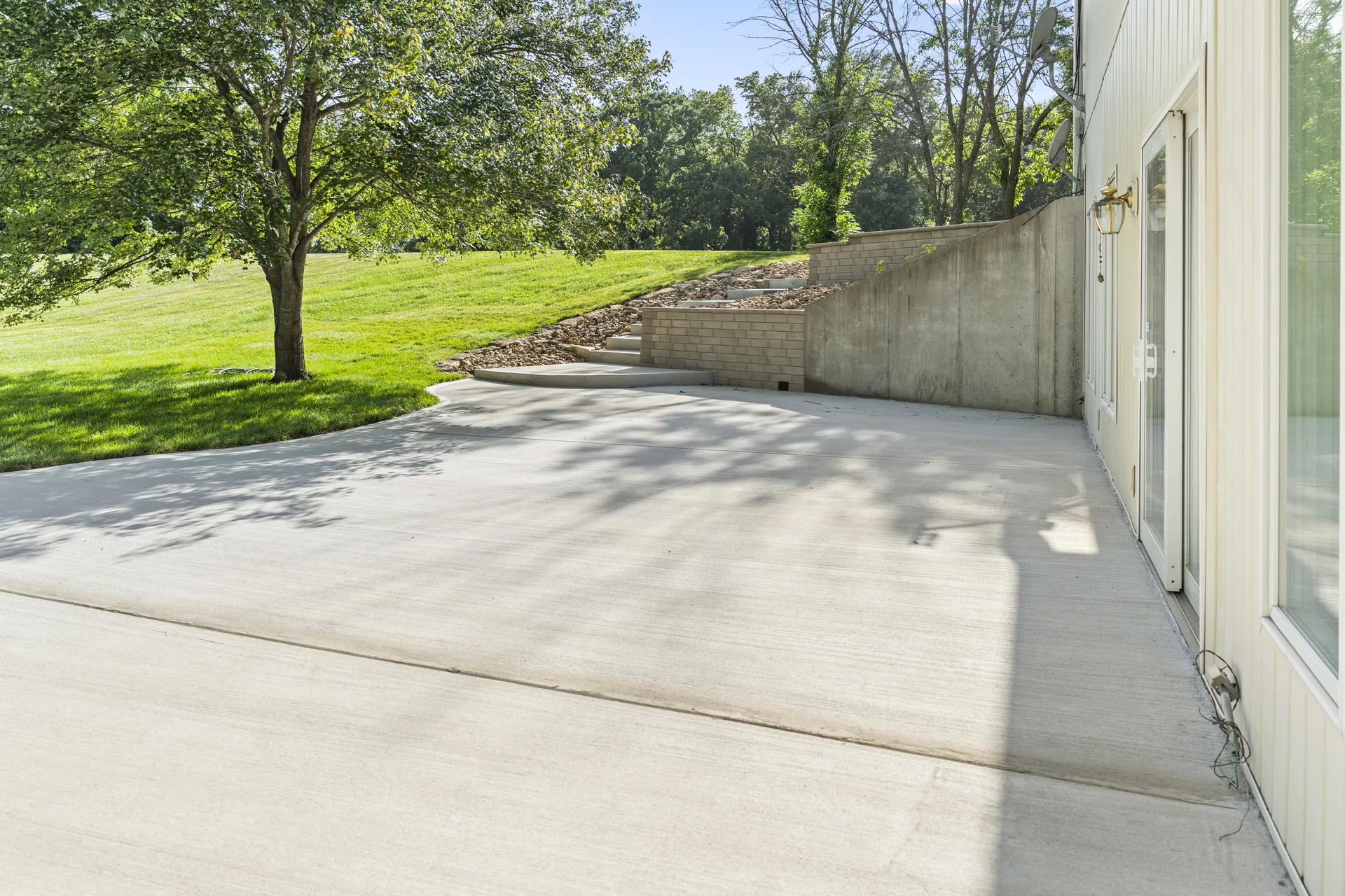 Open concrete patio below the raised yard