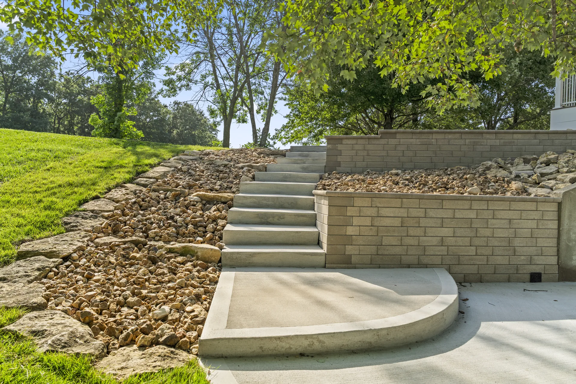 Concrete steps set between block retaining walls