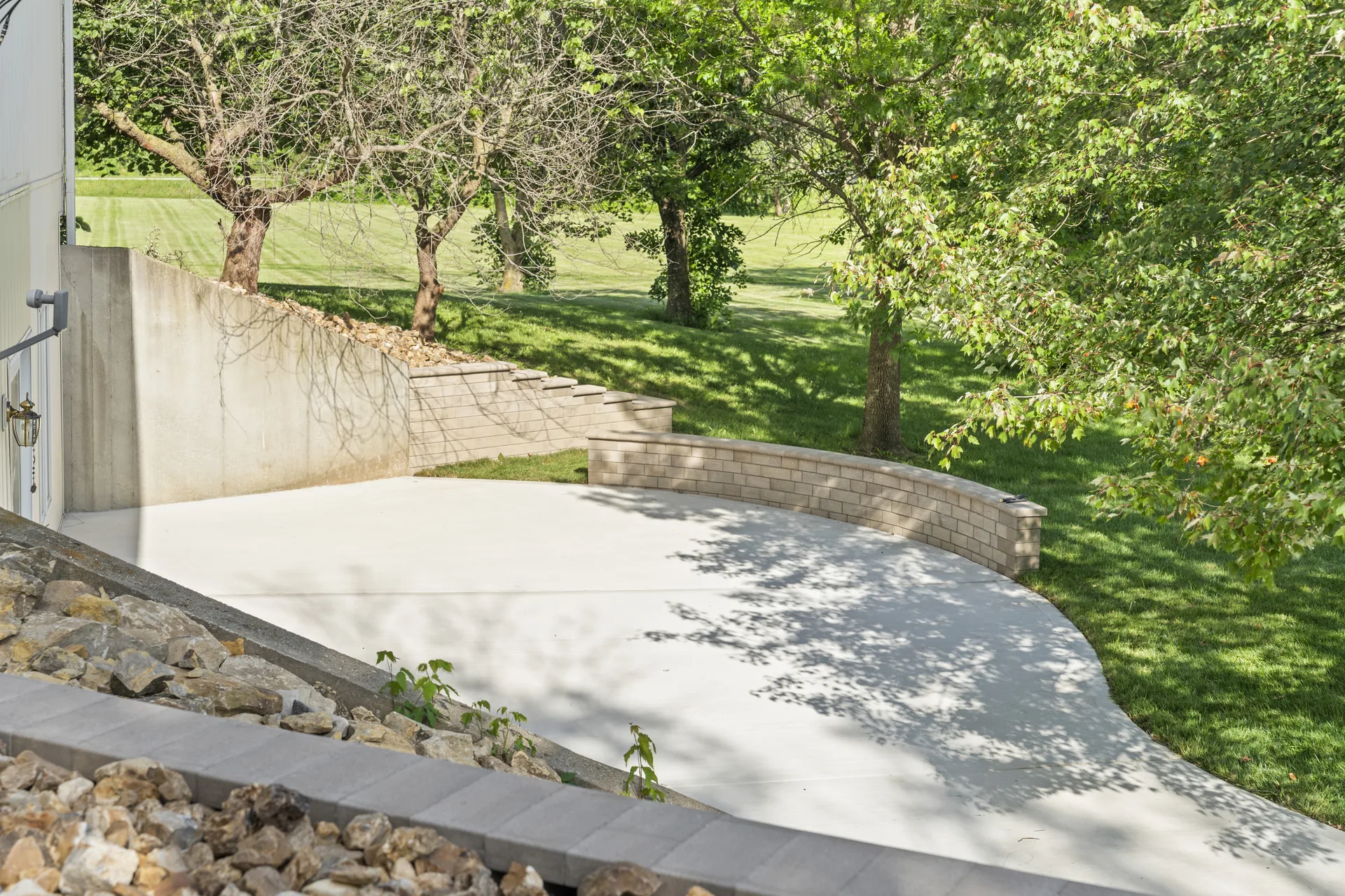 Finished concrete surface beside the curved retaining wall