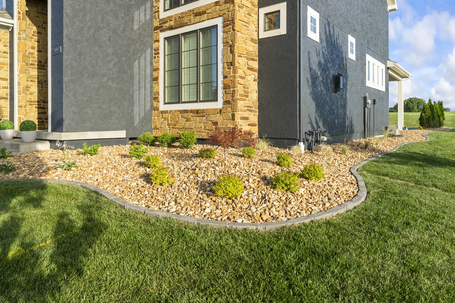 Planting bed wrapping around the front corner of the home