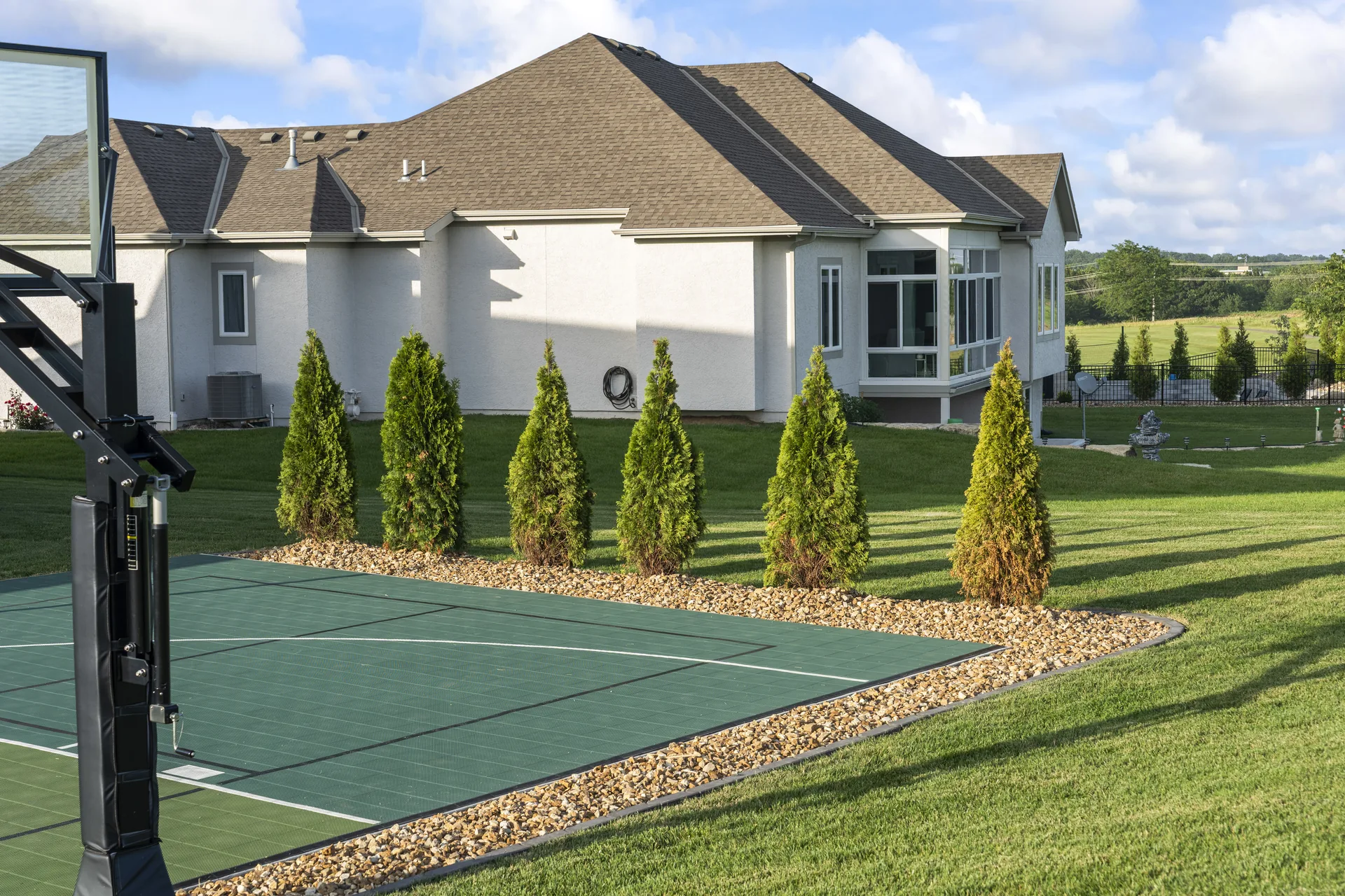 Court boundary bordered by a row of evergreens