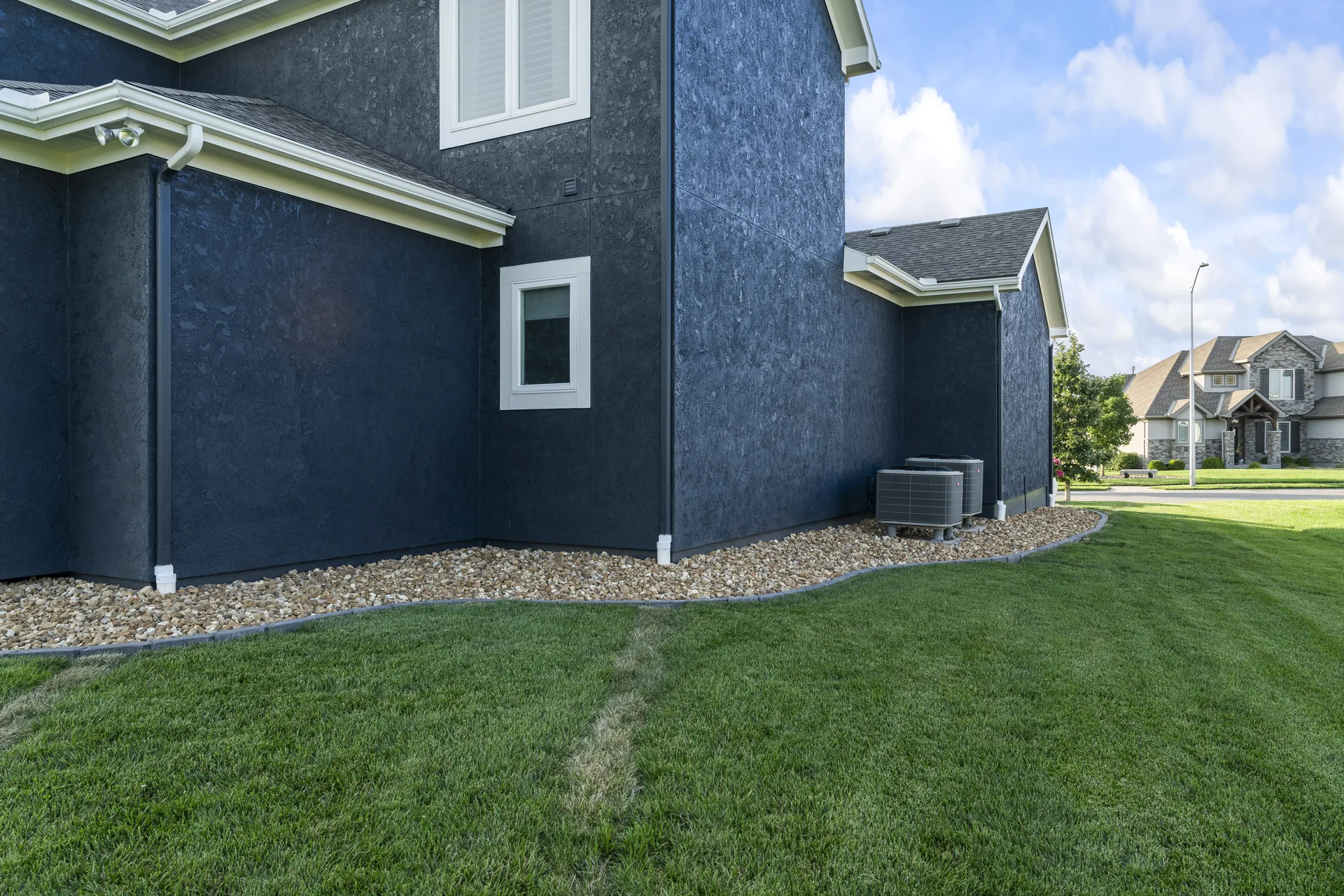Stone-edged bed running along the side of the home