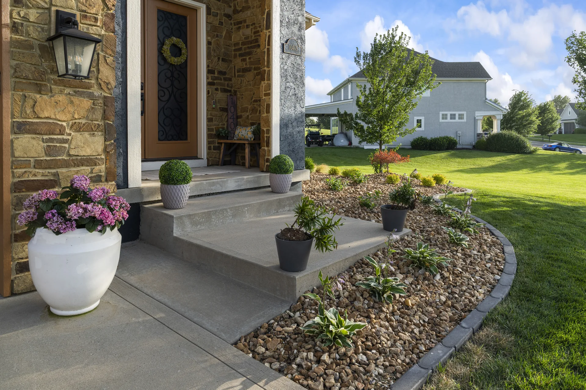 Front porch and curved flower bed near the entrance