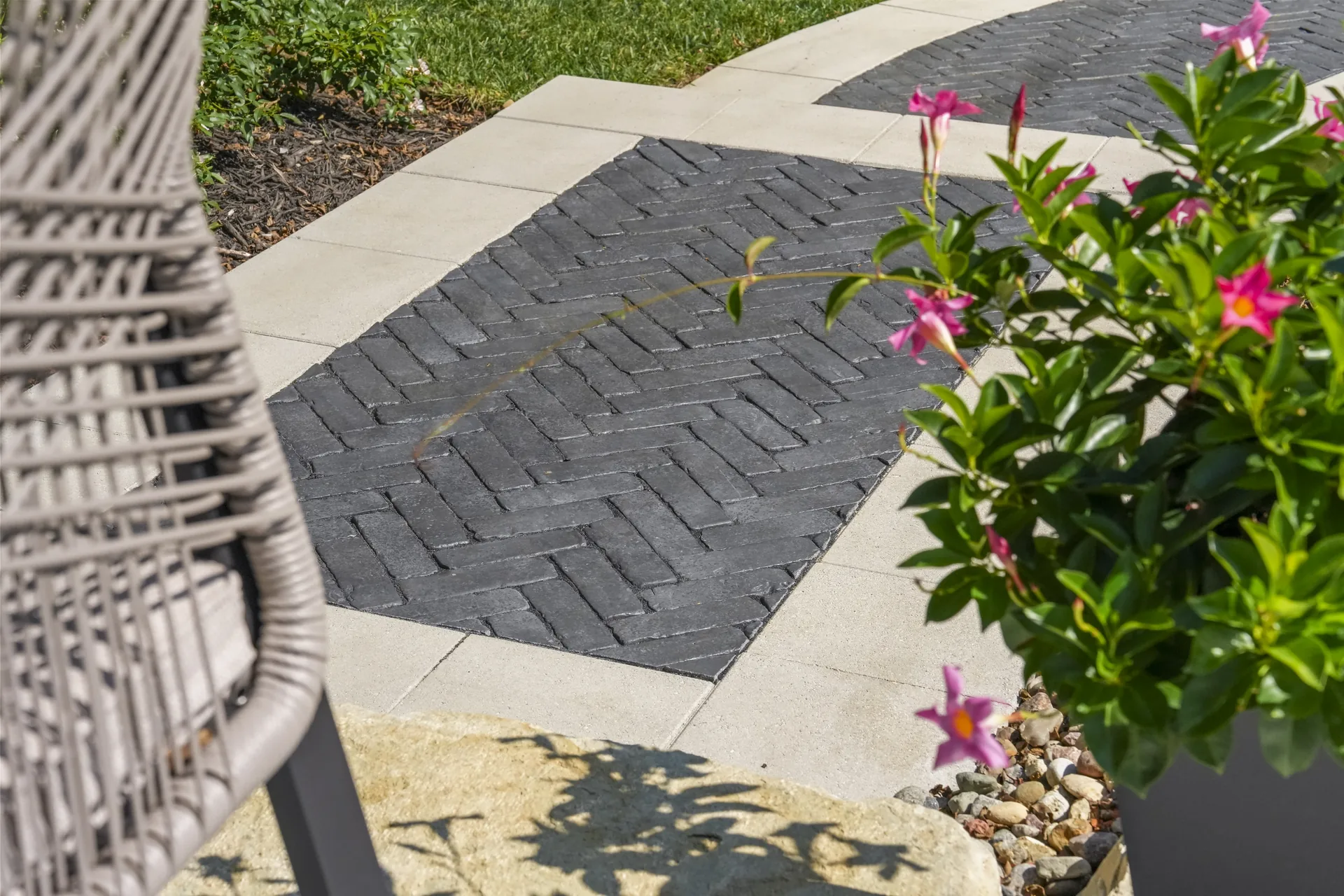 Paver patio with seating seen through tree branches