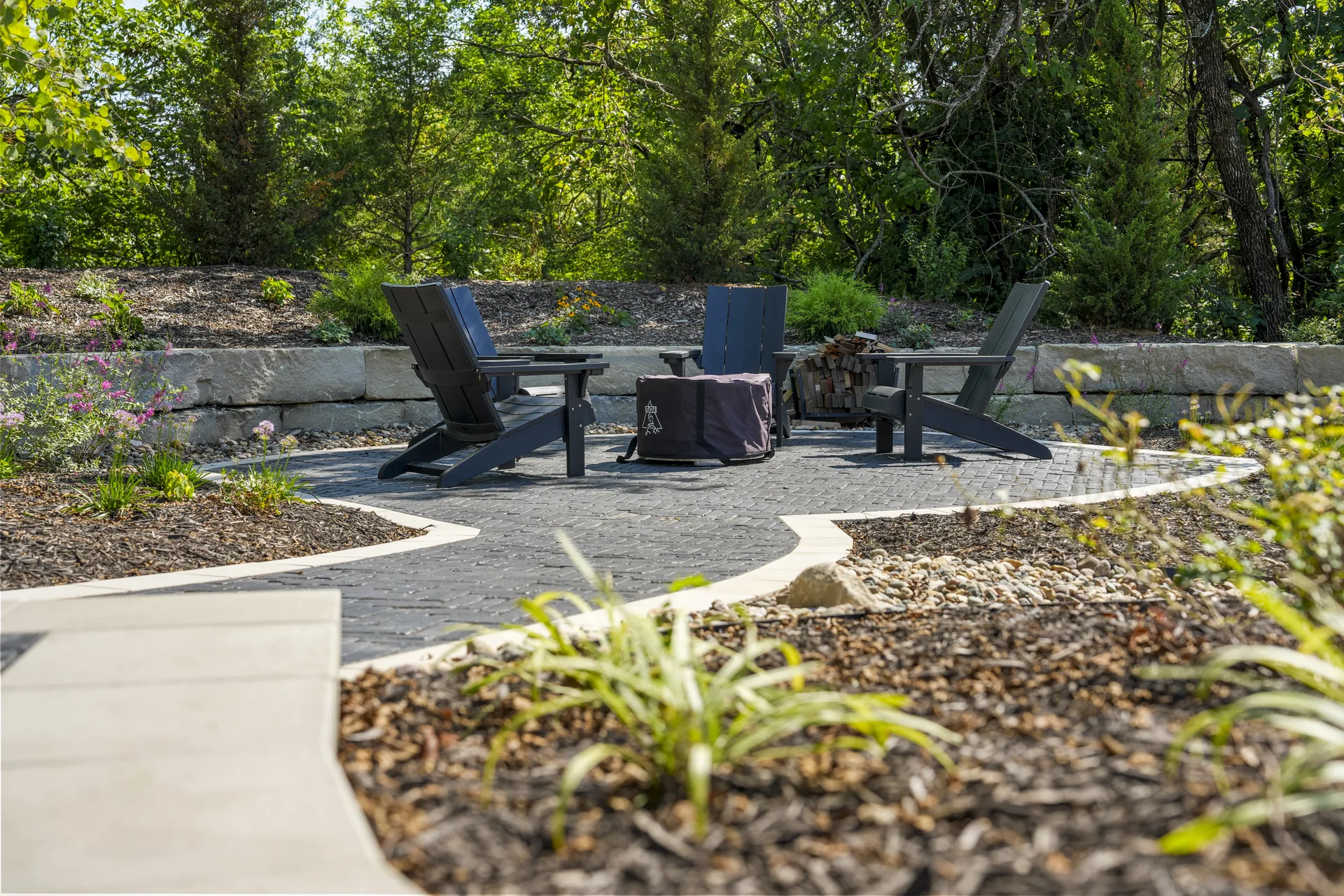 Paver dining and lounge area beneath the trees