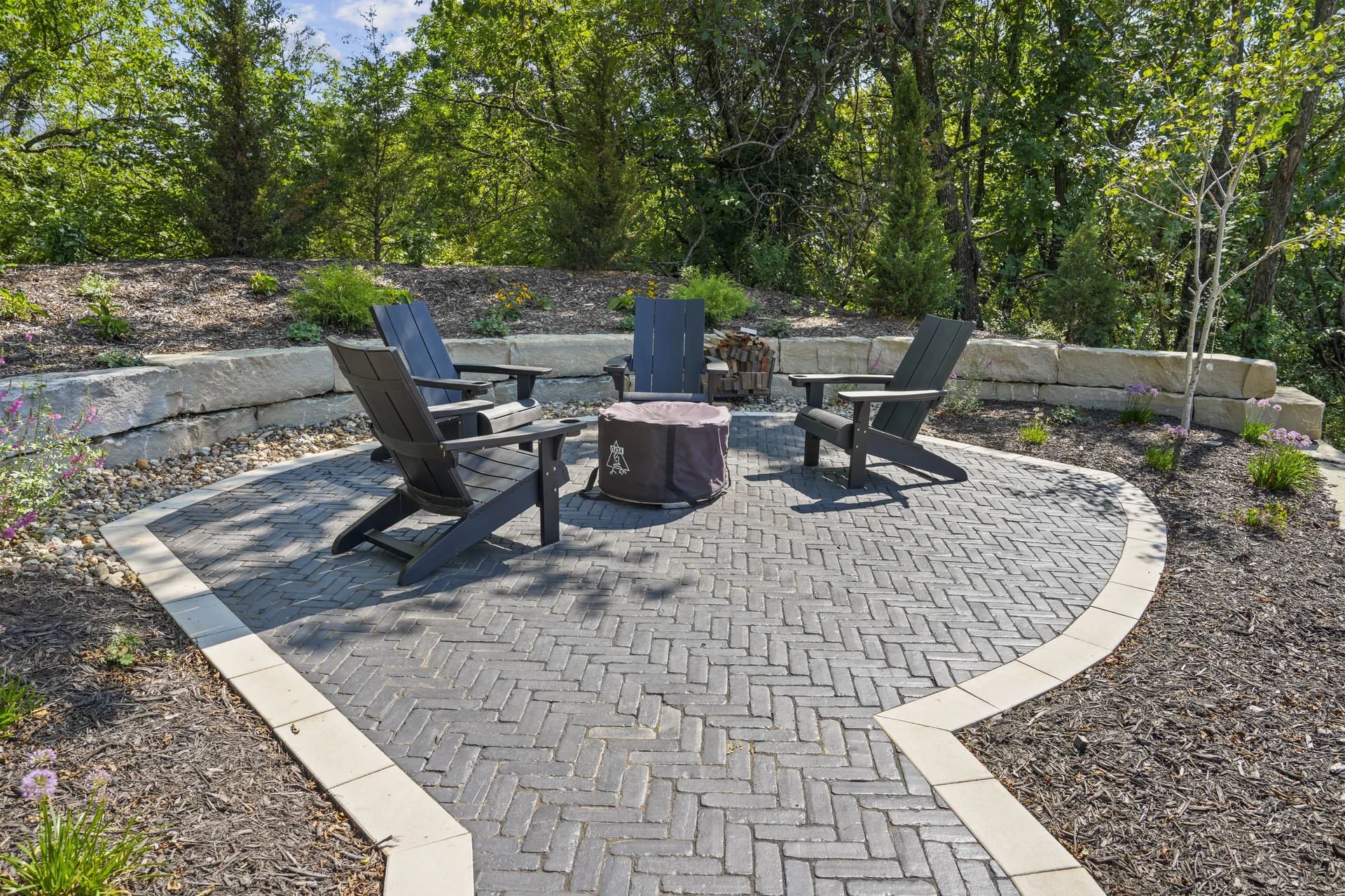 Paver patio with chairs and stone landscape border