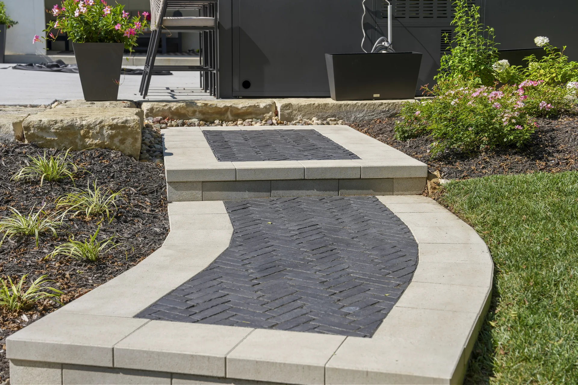 Curved path connecting the house and outdoor patio
