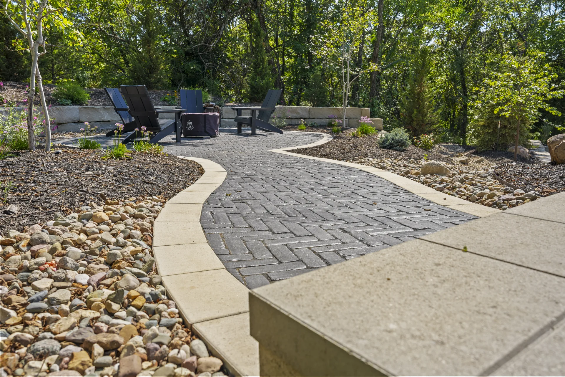 Paver walkway flowing between mulched beds