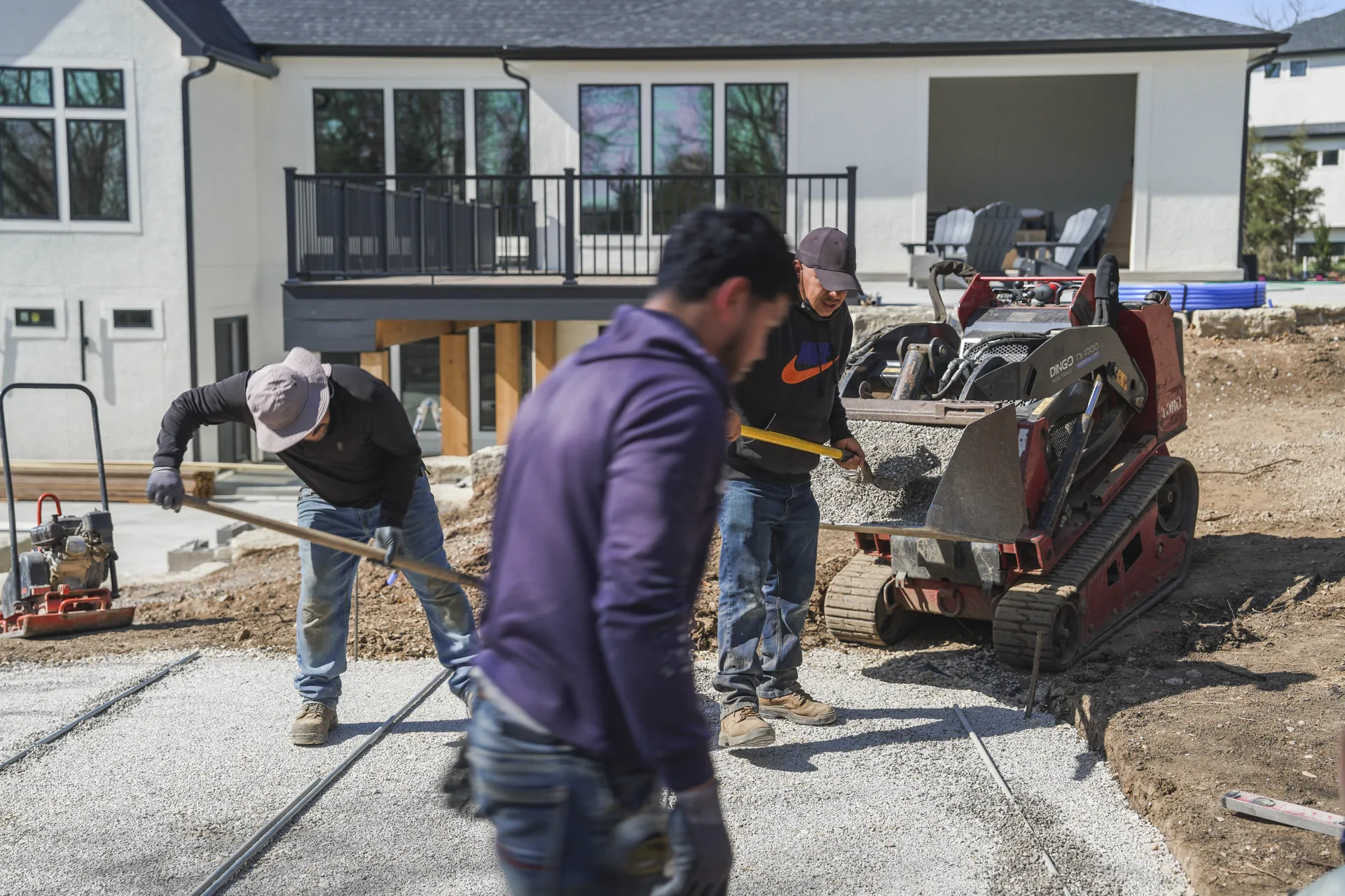 Paver installation work beside the house