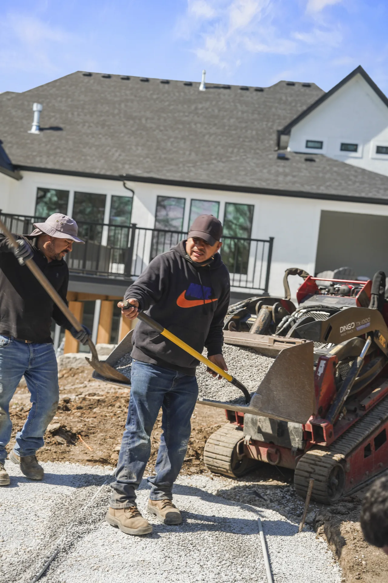 Workers handling paving materials on site