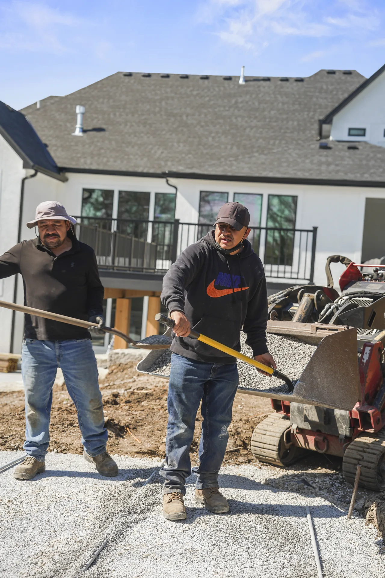 Crew beside the partially finished paver area