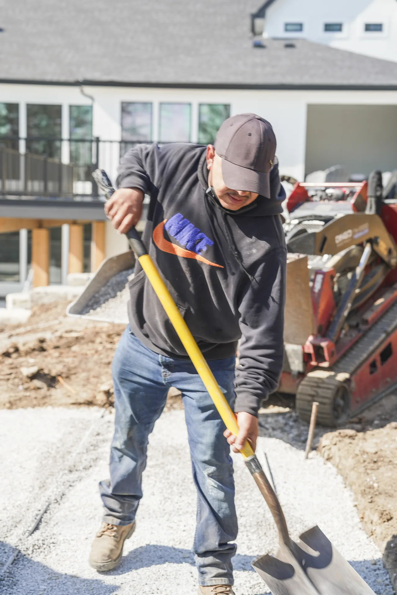 Worker tending the edge of the paver surface