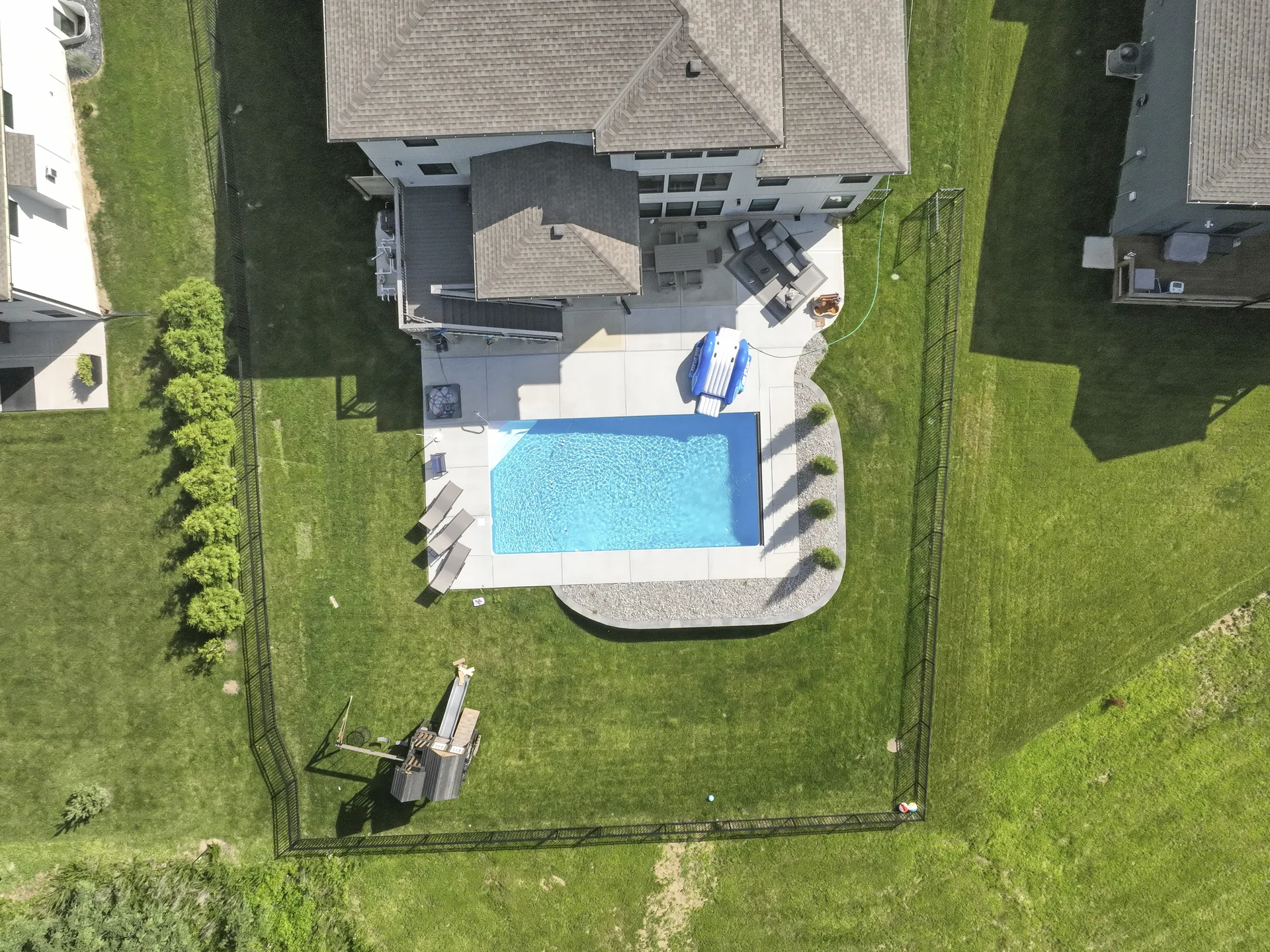 Aerial view of the pool area behind the home