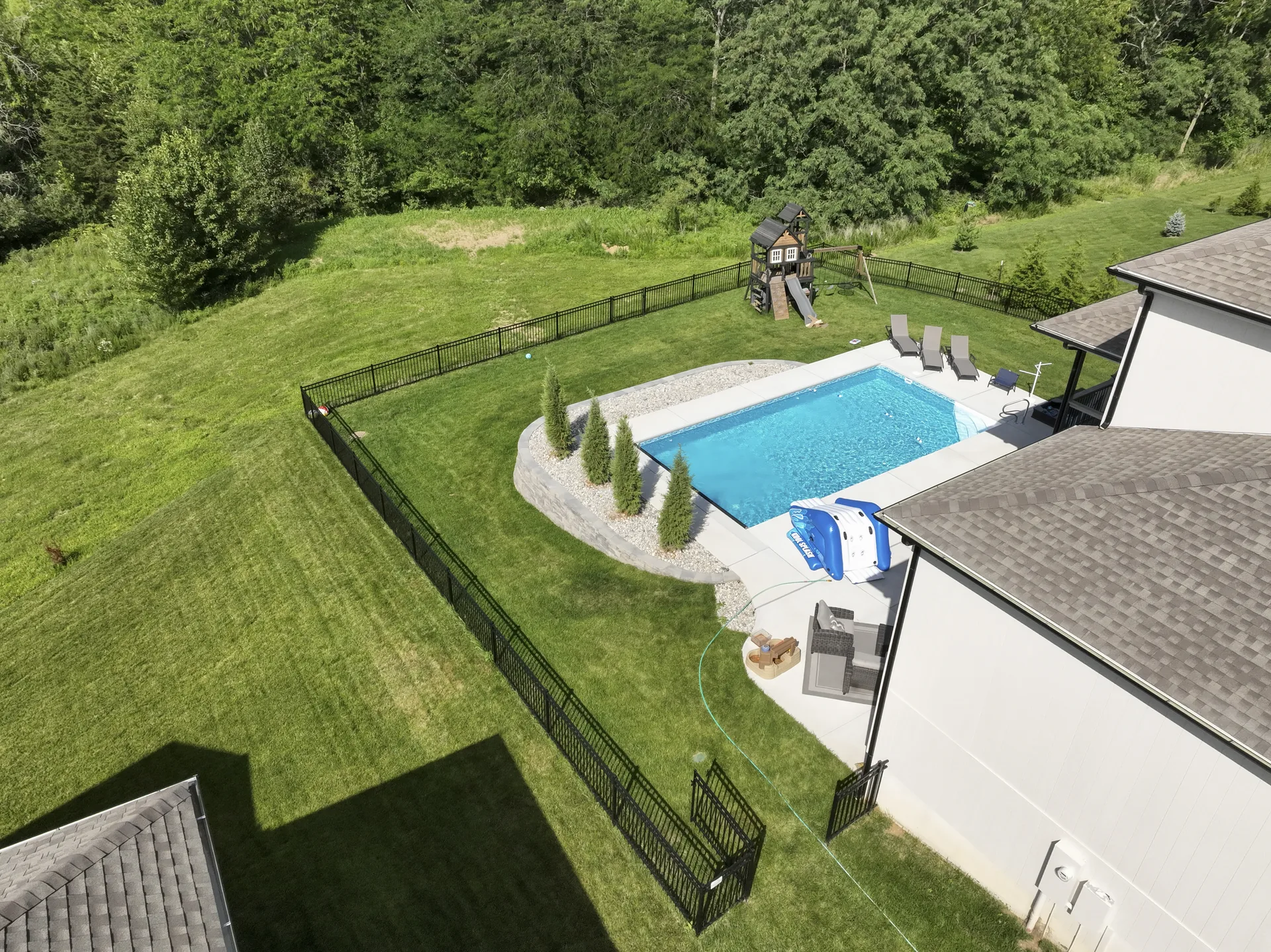 Pool, retaining wall and fence viewed from above