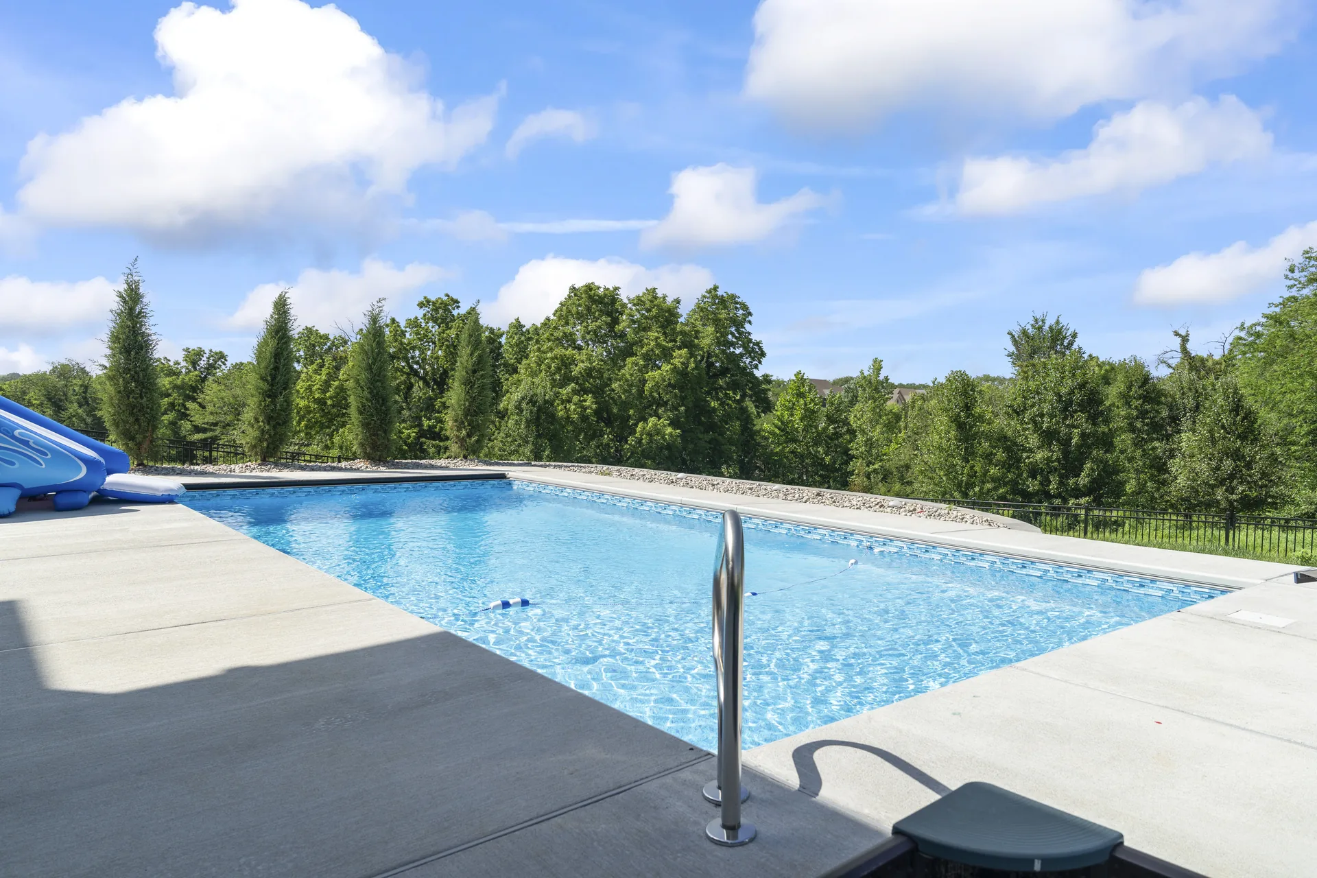Pool water and paved deck seen from the edge