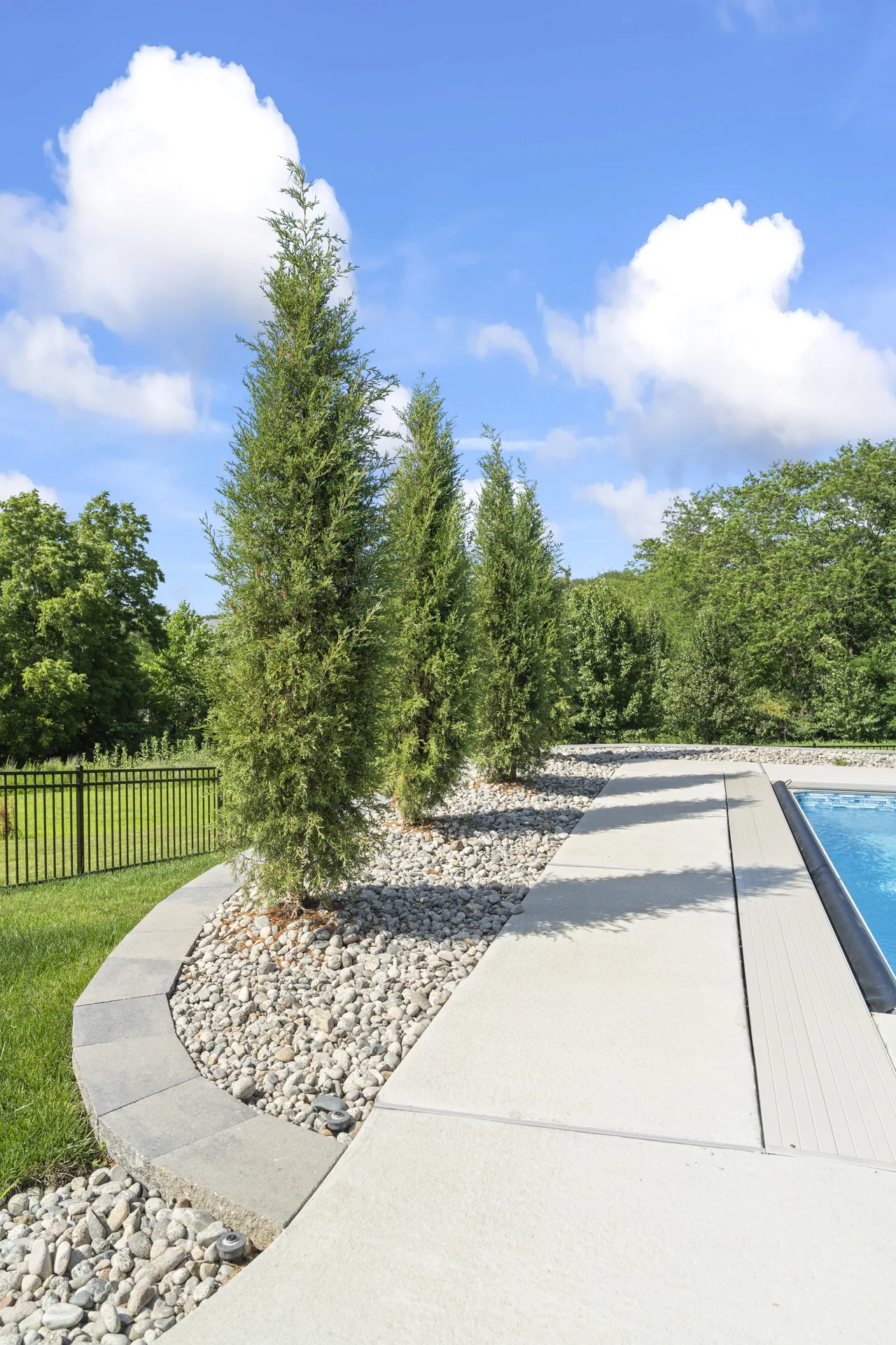 Stone ground cover beside the pool planting bed