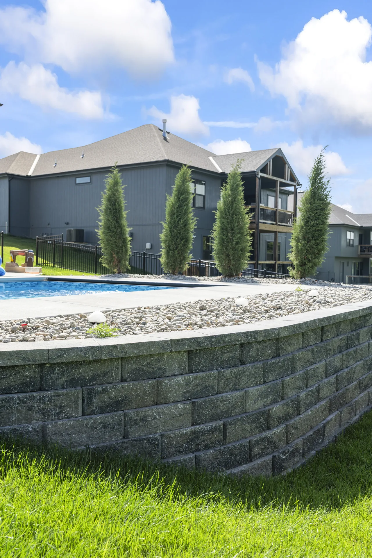 Paved pool surround viewed past the wall