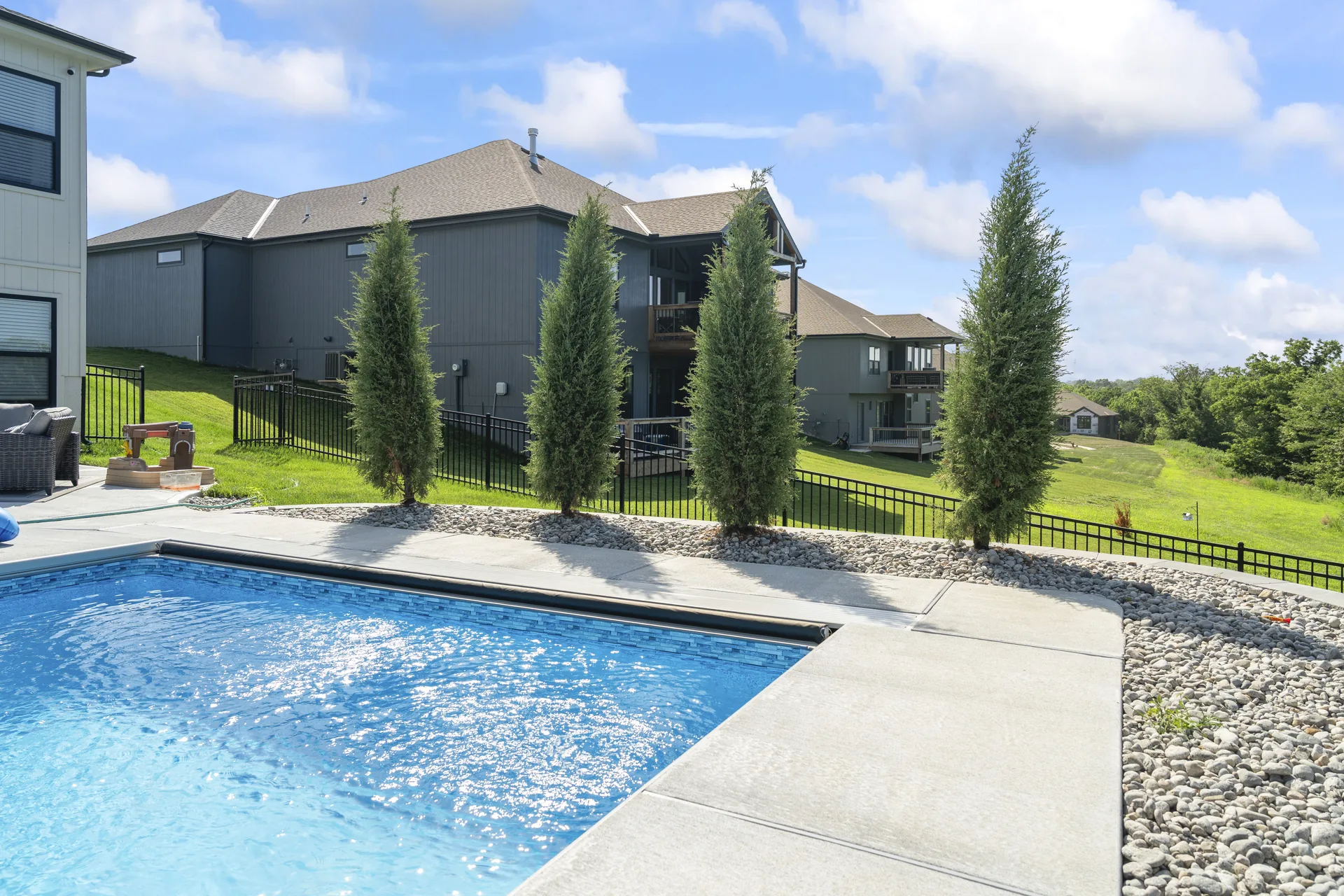 Poolside paving, stone bed and evergreen planting